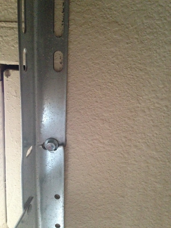 residential garage door rail system damage